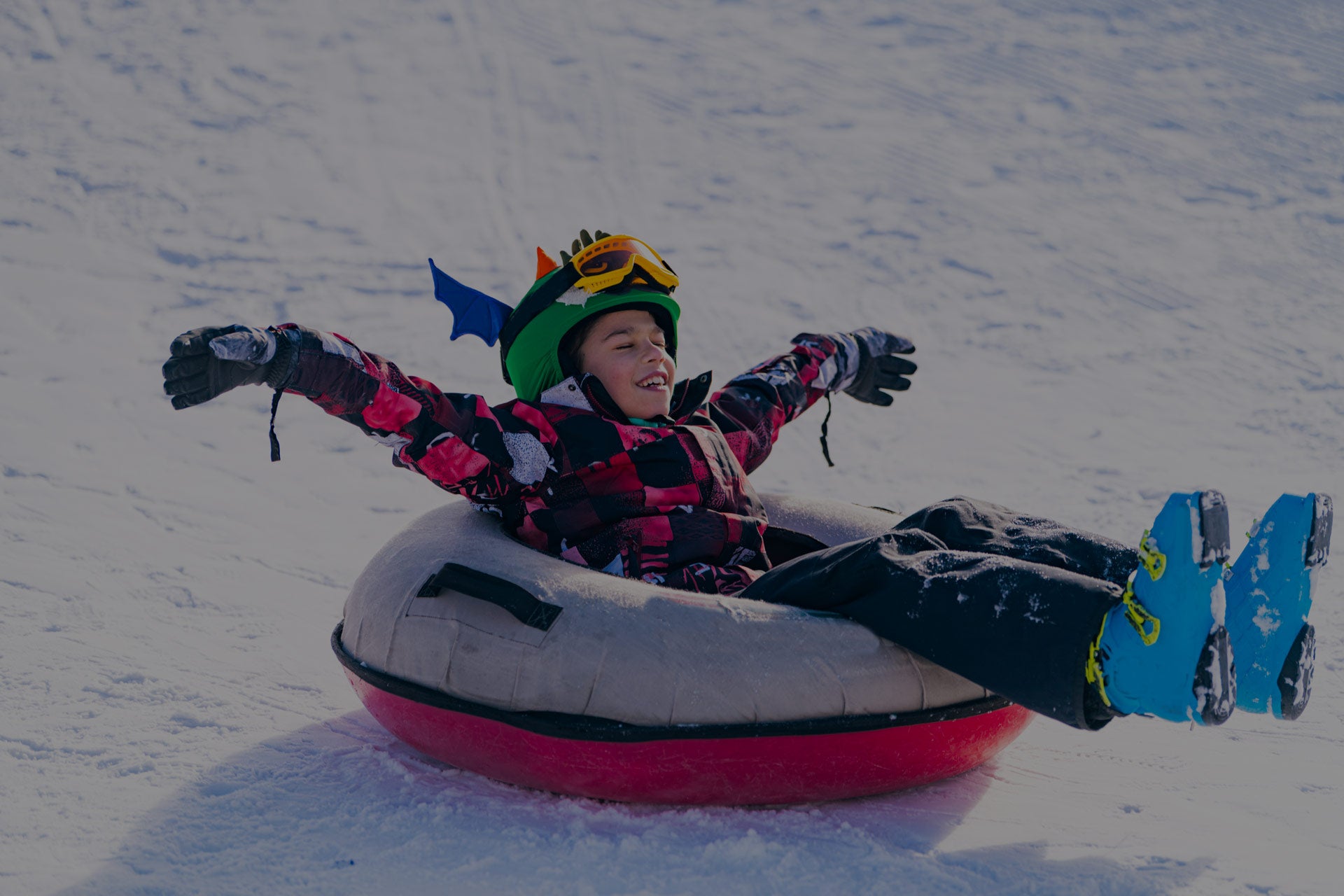 kid in a snow tube