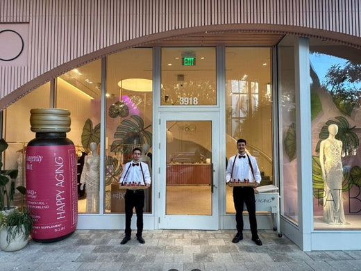 Two men standing next to an bottle inflatable