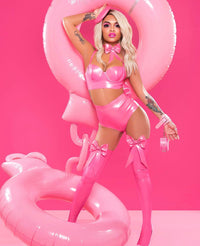 Person in a pink outfit with matching accessories on a pink background