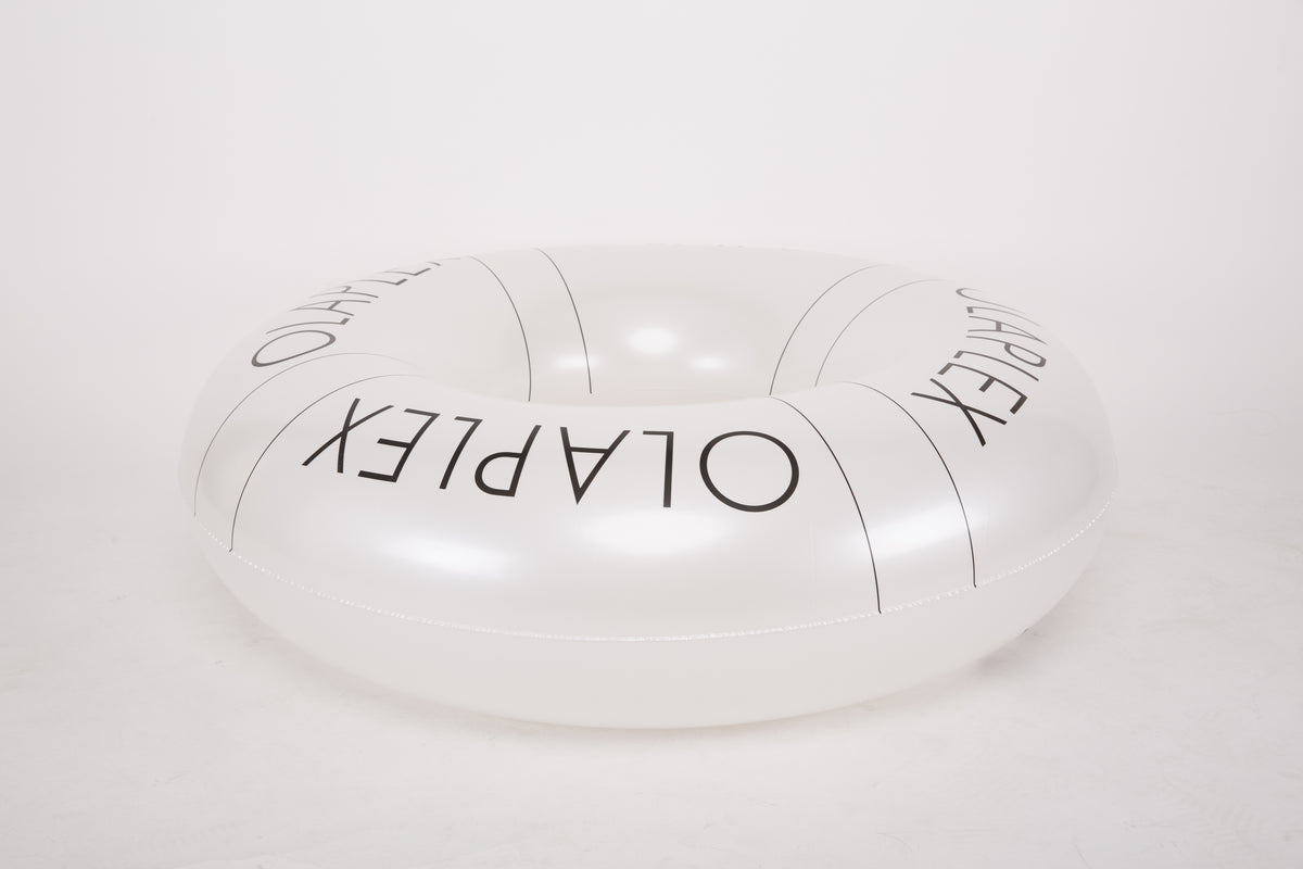 White circular object with 'OLAPEX' branding on a white background