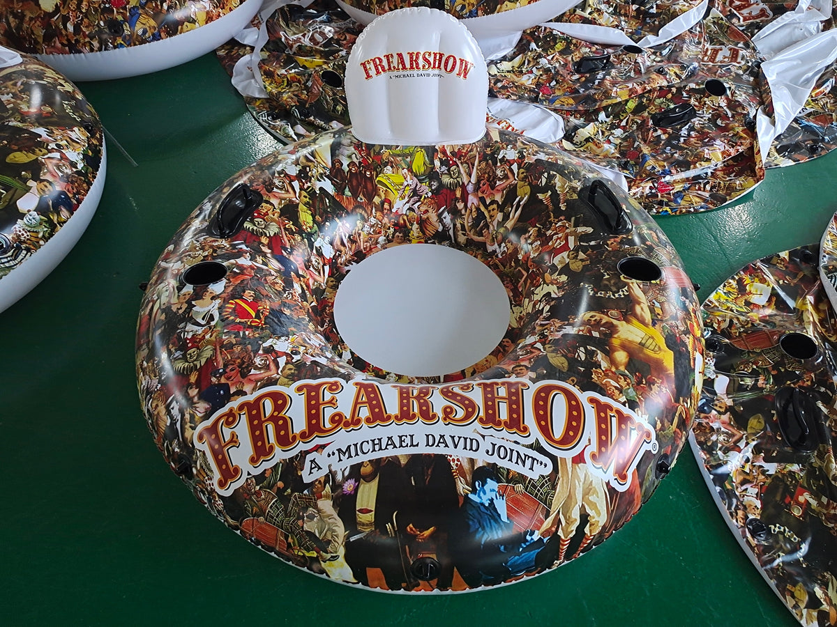Decorative plates with 'Freakshow' design on a green surface