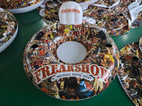 Decorative plates with 'Freakshow' design on a green surface