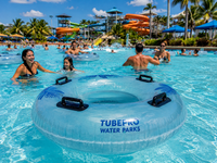People enjoying a pool with Tubefro Water Parks float in the foreground