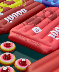 Inflatable pool floats with 'Shirley Temple' branding on a dark background