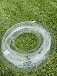 Clear inflatable ring on grass with text '1st Place'