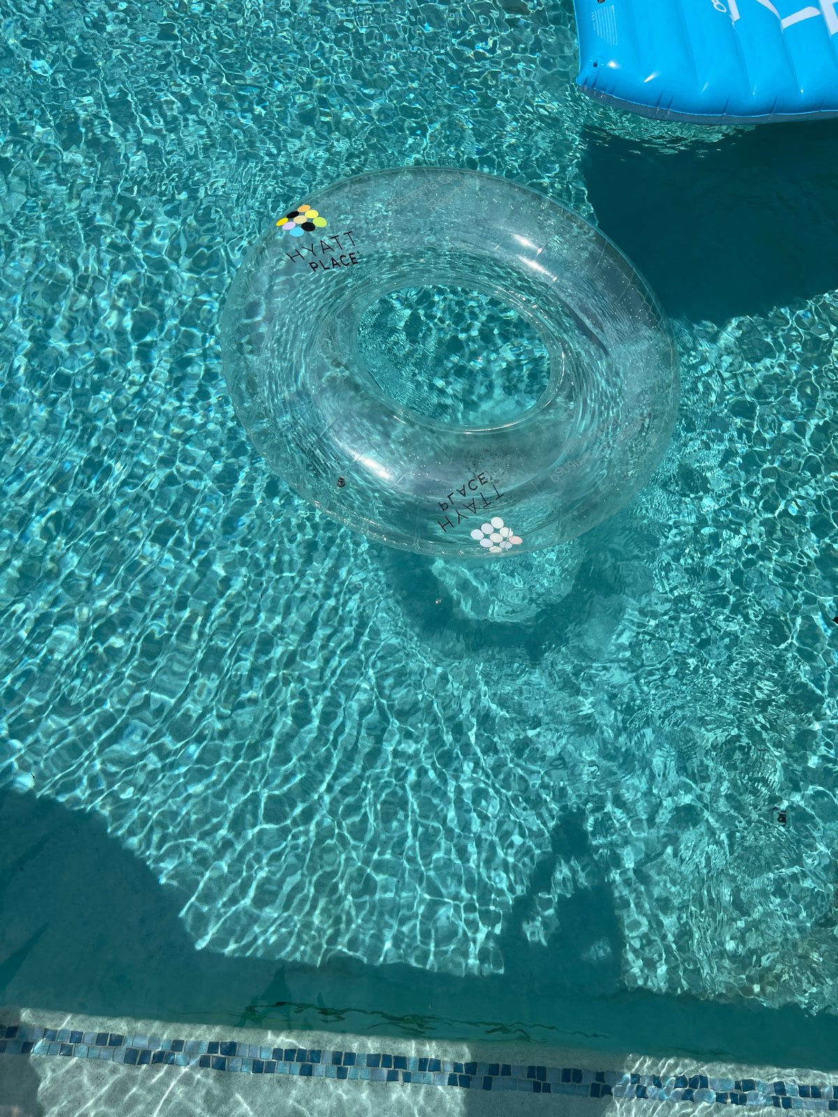 Clear inflatable ring floating in a pool with clear water