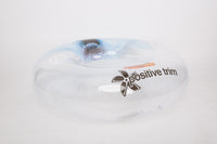 White object with 'positive trim' text and logo on a light gray background