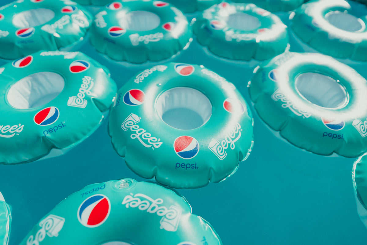 Multiple inflatable rings with Pepsi logo on a blue background
