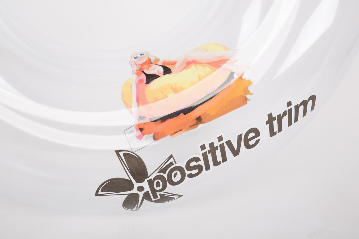 White t-shirt with a cartoon character and 'Positive Trim' text on a white background