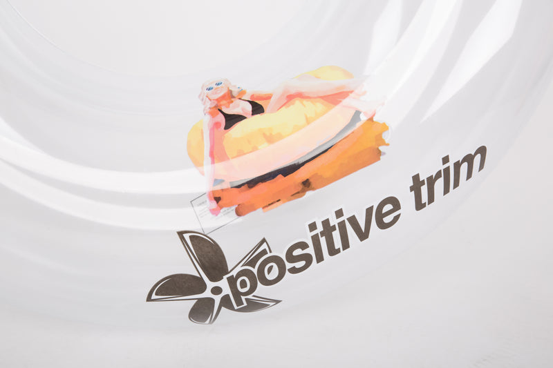 White t-shirt with a cartoon character and 'Positive Trim' text on a white background