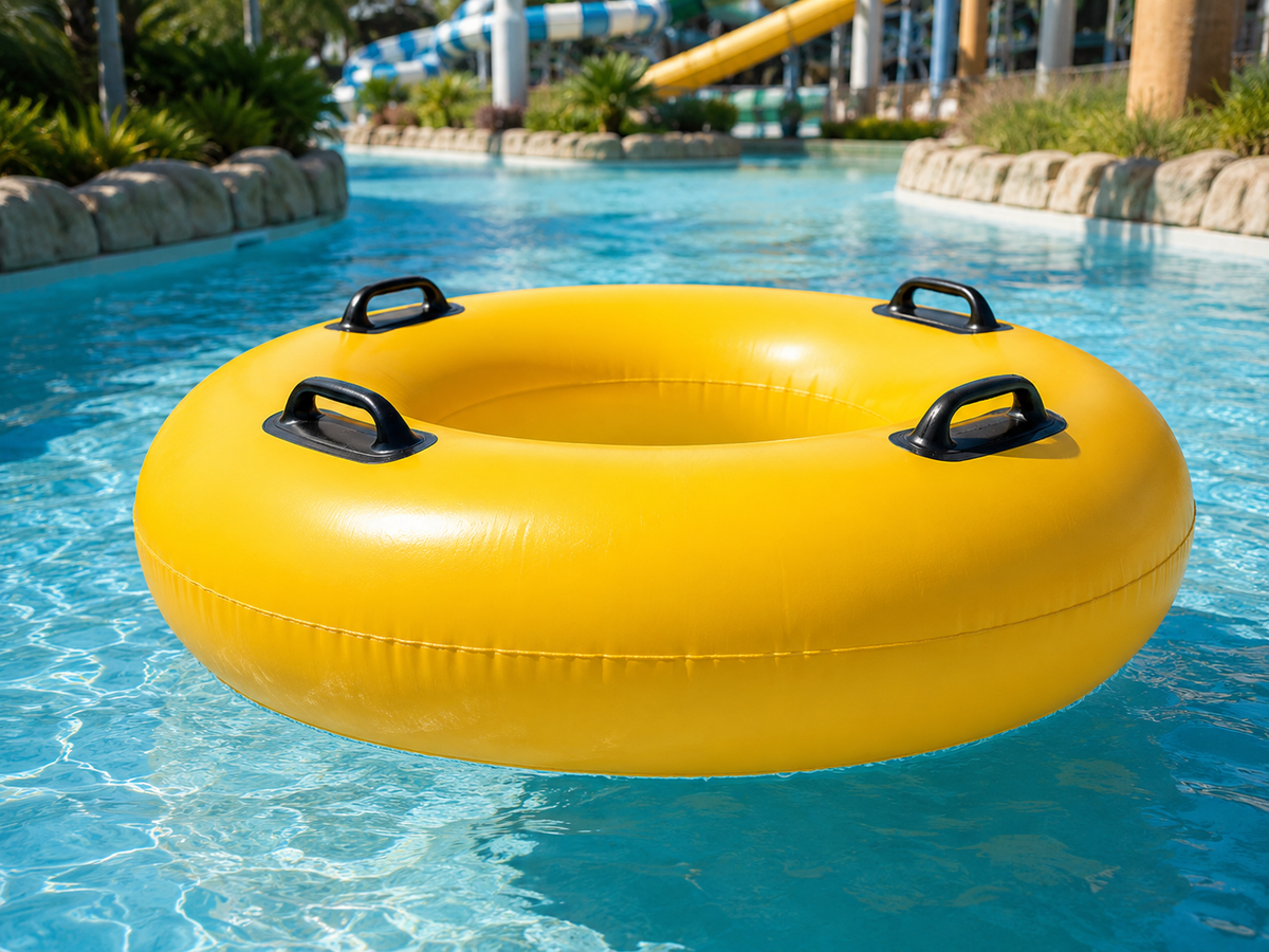 Yellow inflatable tube floating in a pool with water slides in the background